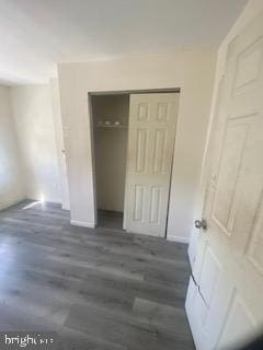 1047 W Nevada St, Philadelphia, PA 19133 - unfurnished bedroom with a closet, baseboards, and wood finished floors
