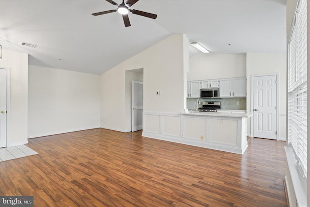 11014 Koman Cir Unit 304, Manassas, VA 20109 - unfurnished living room with vaulted ceiling, visible vents, ceiling fan, and dark wood-style floors