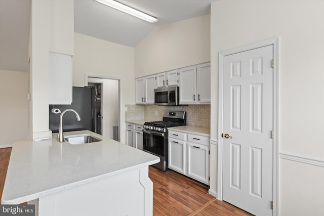 11014 Koman Cir Unit 304, Manassas, VA 20109 - kitchen with a sink, stainless steel appliances, dark wood-style flooring, vaulted ceiling, and tasteful backsplash