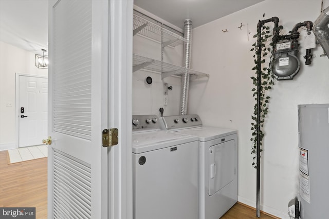 11014 Koman Cir Unit 304, Manassas, VA 20109 - washroom featuring washer and dryer, laundry area, light wood finished floors, and water heater