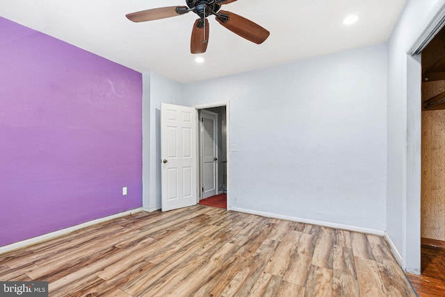 unfurnished bedroom featuring baseboards, a ceiling fan, recessed lighting, and wood finished floors