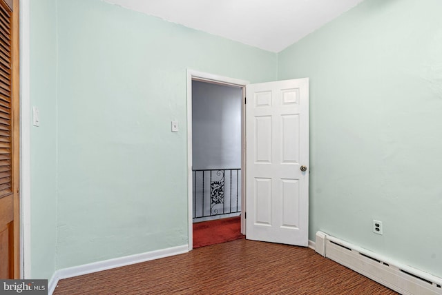 unfurnished bedroom featuring baseboards and a baseboard heating unit