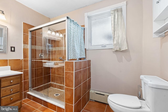 bathroom with toilet, a shower stall, baseboard heating, and tile patterned flooring