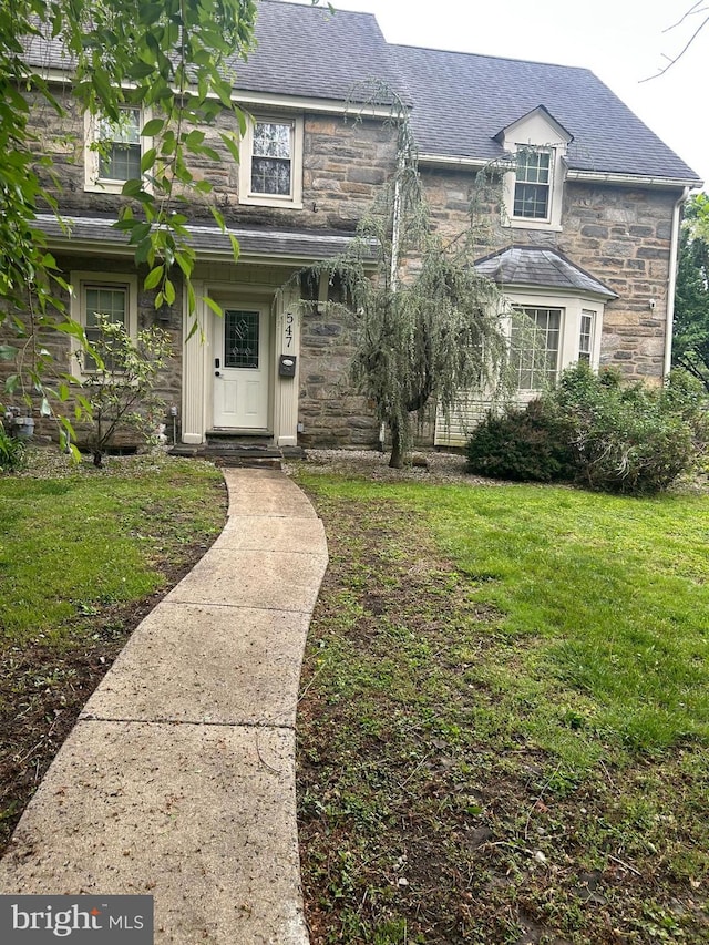 547 Baeder Rd, Jenkintown, PA 19046 - view of front facade featuring stone siding, a front yard, and a shingled roof