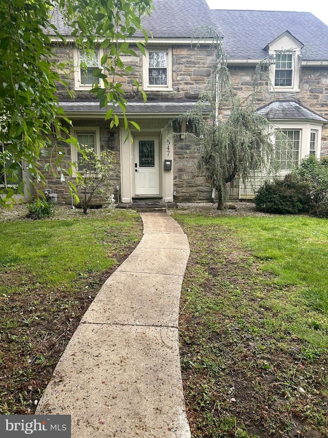 547 Baeder Rd, Jenkintown, PA 19046 - view of front of property featuring stone siding, a front lawn, and roof with shingles