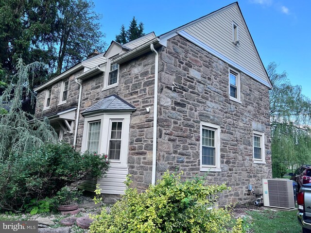 547 Baeder Rd, Jenkintown, PA 19046 - view of property exterior featuring stone siding and cooling unit