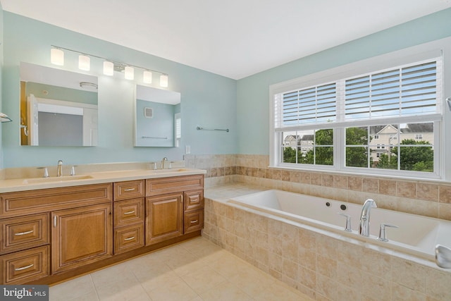 bathroom with double vanity, a sink, tile patterned flooring, and a garden tub