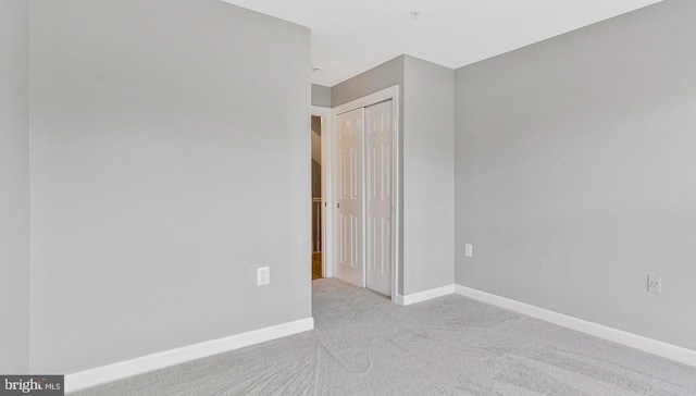 spare room featuring baseboards and carpet