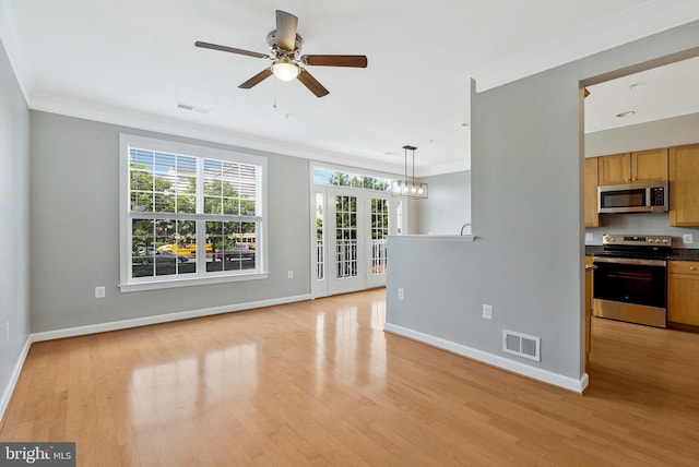 unfurnished living room featuring visible vents, ornamental molding, light wood-style floors, and baseboards