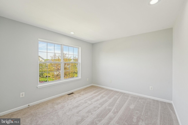 carpeted empty room featuring recessed lighting, baseboards, and visible vents