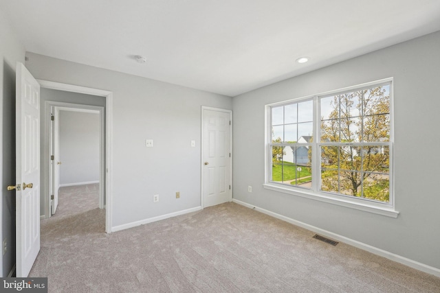 unfurnished bedroom with light colored carpet, baseboards, visible vents, and recessed lighting