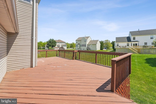 deck featuring a yard and a residential view