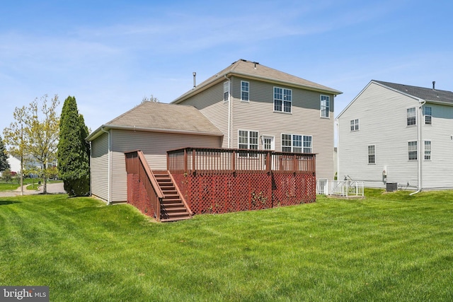 back of property with stairway, a deck, central AC unit, and a lawn