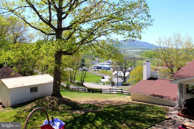 view of yard with fence and a mountain view