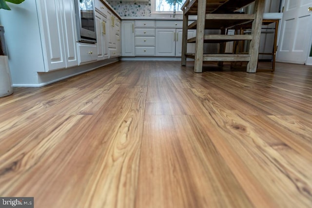 interior space with wood finished floors and oven