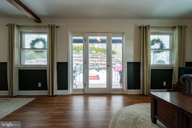 doorway to outside featuring baseboards, ornamental molding, dark wood-style flooring, and beam ceiling