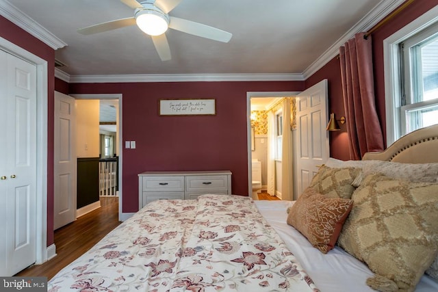 bedroom featuring ensuite bath, a ceiling fan, baseboards, wood finished floors, and ornamental molding