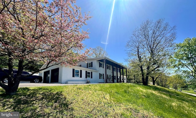 view of front of property featuring an attached garage, driveway, and brick siding