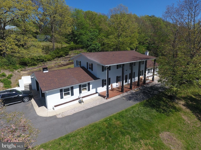 drone / aerial view with a wooded view