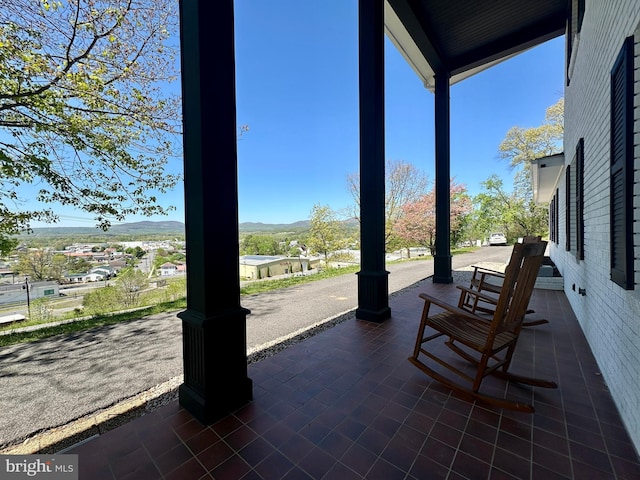 view of patio featuring covered porch and a mountain view