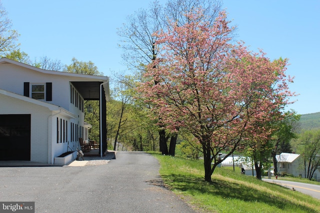 view of property exterior with brick siding and driveway