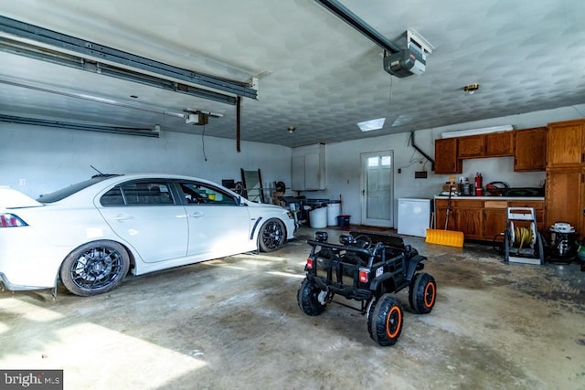 garage with a garage door opener and fridge