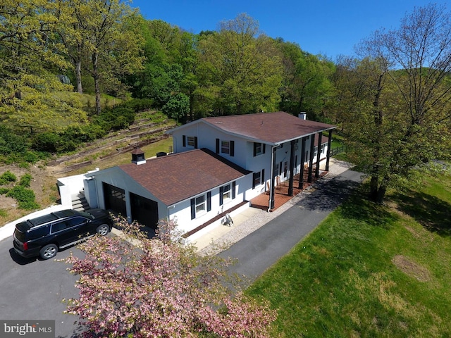 birds eye view of property with a view of trees