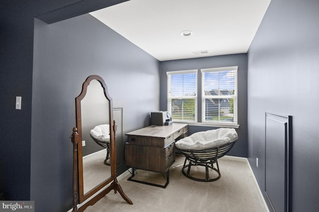 office space with baseboards, visible vents, and light colored carpet