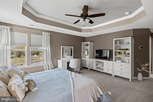 carpeted bedroom with crown molding, a raised ceiling, a ceiling fan, and visible vents