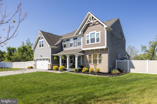 craftsman inspired home with a garage, fence, driveway, and a front yard