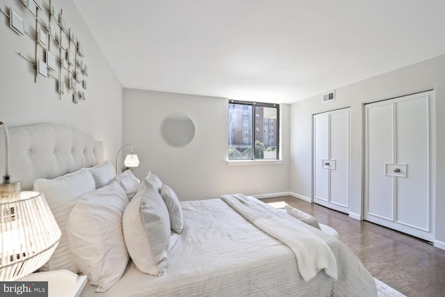 bedroom with baseboards and visible vents