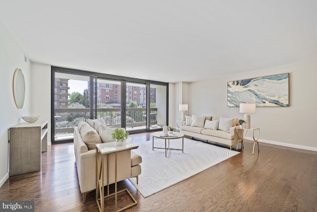 living area with baseboards, wood finished floors, and expansive windows
