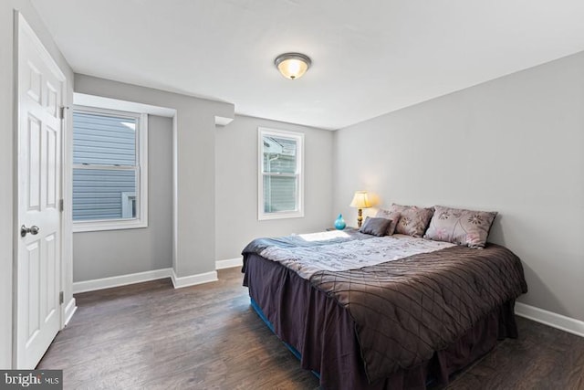 bedroom with baseboards and wood finished floors