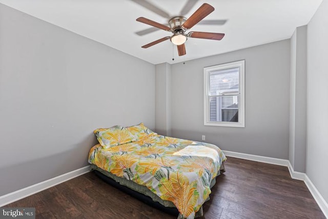 bedroom featuring baseboards, a ceiling fan, and wood finished floors