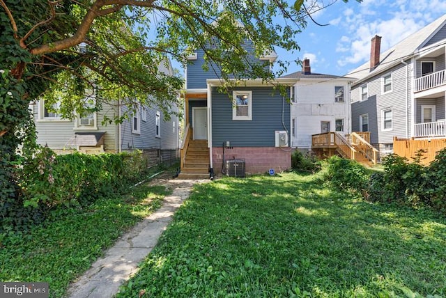 view of front of property with stairs and a front lawn