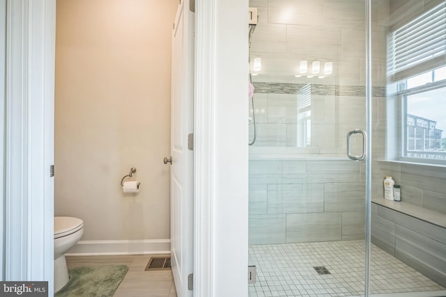 22528 Wilson View Ter, Ashburn, VA 20148 - bathroom with visible vents, baseboards, toilet, and a shower stall