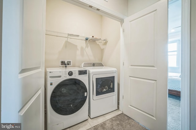 22528 Wilson View Ter, Ashburn, VA 20148 - washroom with light tile patterned floors, laundry area, and washer and clothes dryer