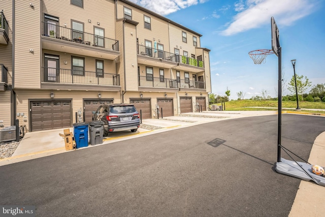 22528 Wilson View Ter, Ashburn, VA 20148 - view of building exterior featuring a garage, driveway, and central AC unit