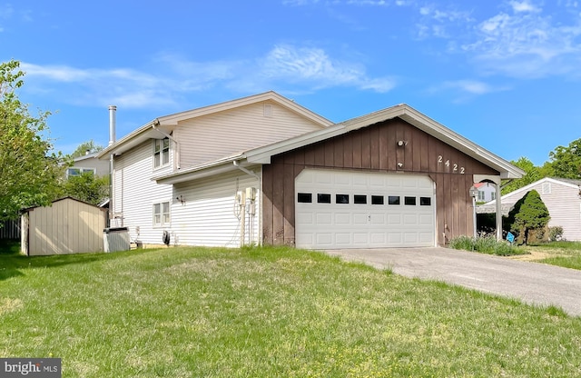 2422 Pinefield Rd, Waldorf, MD 20601 - view of side of property featuring a storage unit, a garage, an outbuilding, concrete driveway, and a yard