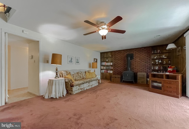 2422 Pinefield Rd, Waldorf, MD 20601 - living area with a ceiling fan, visible vents, a wood stove, built in shelves, and carpet