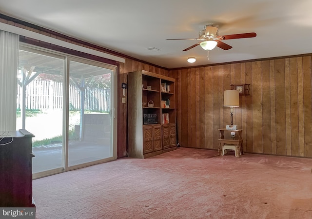 2422 Pinefield Rd, Waldorf, MD 20601 - unfurnished living room with a ceiling fan, carpet flooring, wood walls, and visible vents