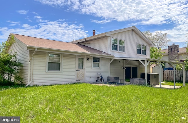 2422 Pinefield Rd, Waldorf, MD 20601 - rear view of house with a lawn and fence