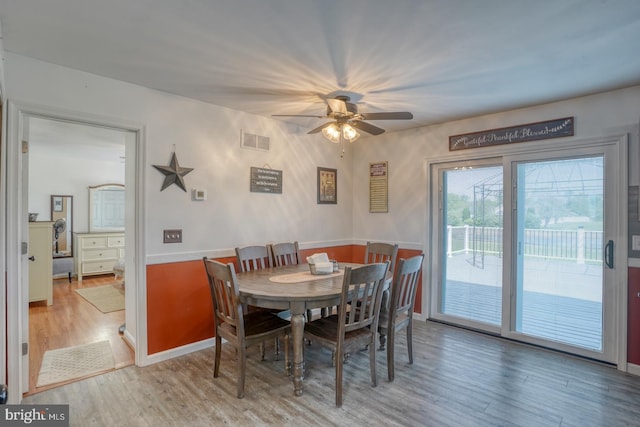 dining room featuring ceiling fan, visible vents, and light wood-style floors