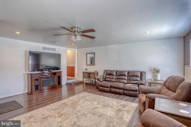 living area with ceiling fan, visible vents, wood finished floors, baseboards, and recessed lighting