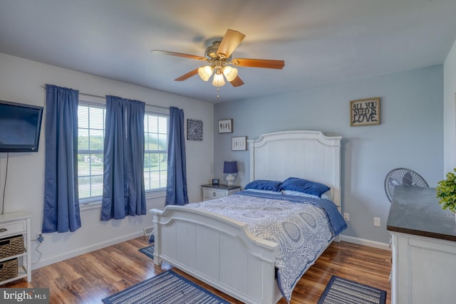 bedroom featuring baseboards, ceiling fan, and wood finished floors