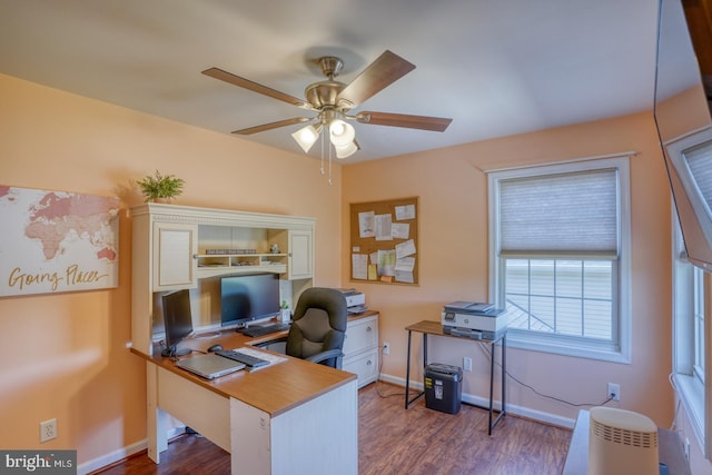 office area featuring baseboards, ceiling fan, and wood finished floors