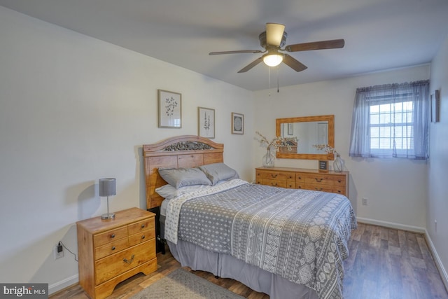 bedroom with a ceiling fan, baseboards, and wood finished floors