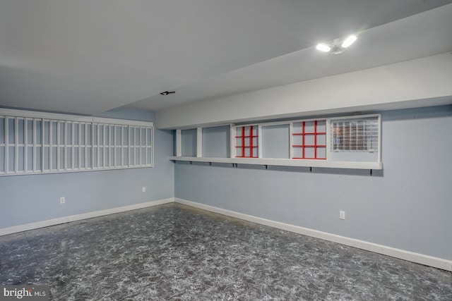 empty room with baseboards and concrete floors