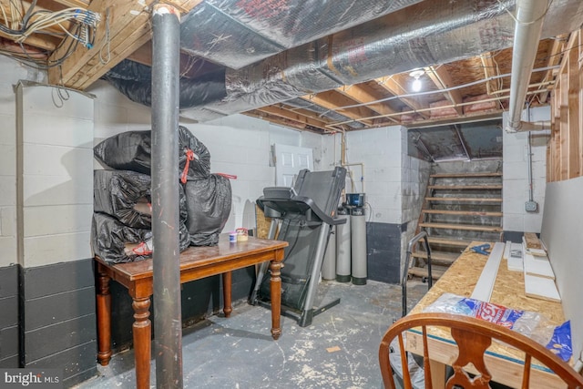 unfinished basement featuring stairs