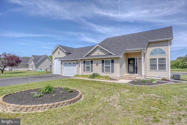 view of front facade featuring an attached garage, driveway, and a front lawn